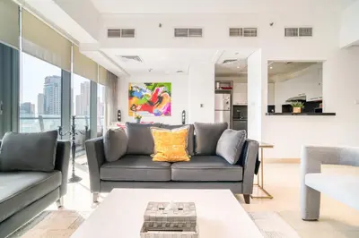 a living room with a couch and a table at Silverene Tower A, Dubai Marina - Mint Stay in Dubai