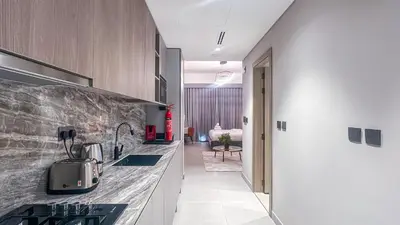 a kitchen with a sink and a counter top at Stylish Studio with Modern Comfort & Luxury - 2AB06 in Dubai