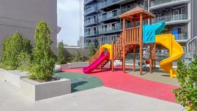 a playground with a slide in front of a building at Stylish Studio with Modern Comfort & Luxury - 2AB06 in Dubai