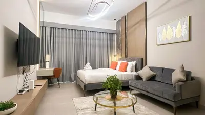 a living room with a bed and a couch at Stylish Studio with Modern Comfort & Luxury - 2AB06 in Dubai