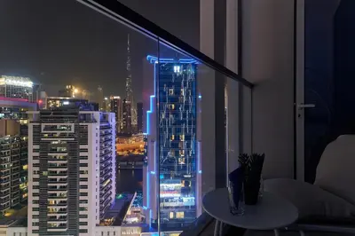 a room with a view of a city at night at Burj Khalifa view cozy studio in Dubai
