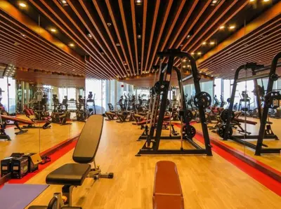 a gym with a large room with many tread machines at Burj Khalifa view cozy studio in Dubai