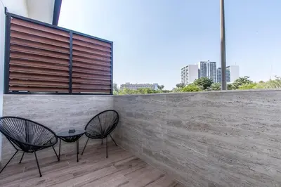two chairs and a table on top of a wall at Modern & Cozy JVC Studio Couple or Solo in Dubai