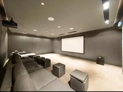 a theater room with a couch and a screen at Modern & Cozy JVC Studio Couple or Solo in Dubai