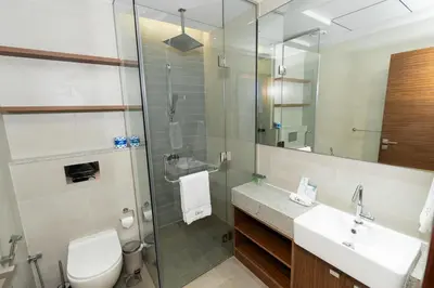 a bathroom with a toilet and a sink and a shower at CitiHome - Spacious 2BR - Park Gate Residences in Dubai