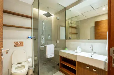 a bathroom with a toilet and a sink and a shower at CitiHome - Spacious 2BR - Park Gate Residences in Dubai
