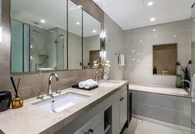 a bathroom with a sink and a tub and a mirror at Luxurious Burj Vista Apartment with Burj Khalifa view in Downtown Dubai in Dubai