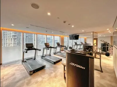 a gym with treadmills and cardio equipment in a building at Luxurious Burj Vista Apartment with Burj Khalifa view in Downtown Dubai in Dubai