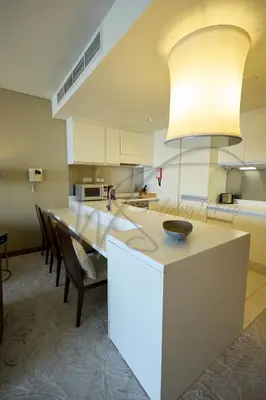 a kitchen with a large white island in a room at EMAAR Residences Fashion Avenue 1BHK by WS Holiday Homes in Dubai