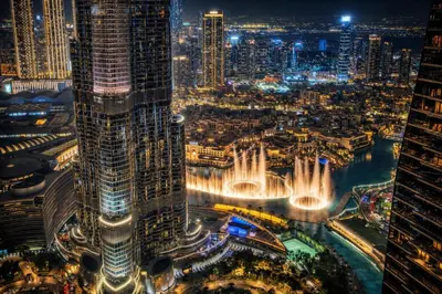 a view of a city at night with a fountain at High Rise Building in Burj Vista with Burj Khalifa View in Dubai