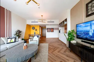 a living room with a large flat screen tv at High Rise Building in Burj Vista with Burj Khalifa View in Dubai