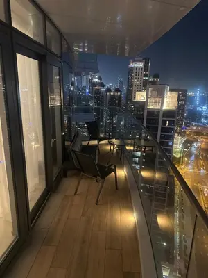 a balcony with two chairs and a view of the city at have fun with your family and friends in our apt in Dubai
