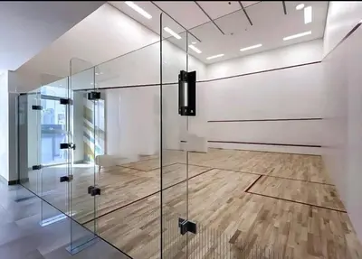 a glass elevator in a room with a wooden floor at have fun with your family and friends in our apt in Dubai