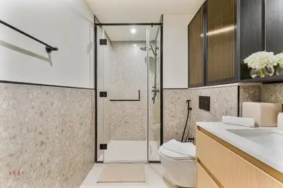 a bathroom with a shower and a toilet and a sink at Executive 1BR at Hadley Heights, JVC Dubai with balcony City Views in Dubai