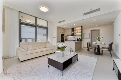 a living room with a couch and a table at Executive 1BR at Hadley Heights, JVC Dubai with balcony City Views in Dubai
