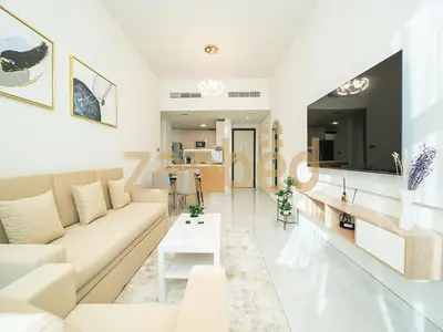 a white living room with a couch and a table at Stylish 2BR Apartment Skyz By Danube Arjan in Dubai