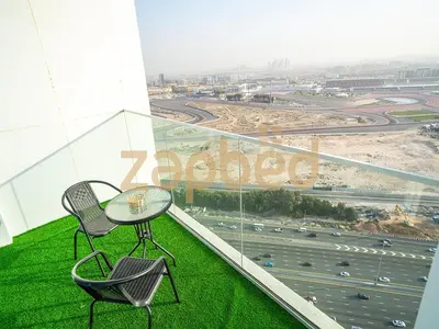 a table and two chairs sitting on top of a building at Stylish 2BR Apartment Skyz By Danube Arjan in Dubai