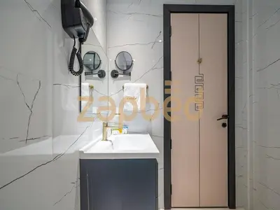 a bathroom with a sink and a phone on a wall at Stylish 2BR Apartment Skyz By Danube Arjan in Dubai
