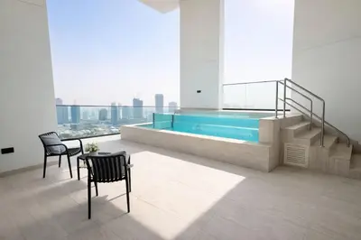 a room with a swimming pool and a table and chairs at Luxury 2BR W Private Pool Binghattti Onyx in Dubai