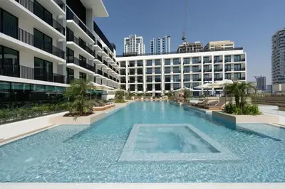 a large swimming pool in the middle of a building at Premium Studio W Pool & Gym Binghatti Aurora in Dubai