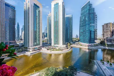 a city with tall buildings and a river at Daniels Studio with Lake View in JLT in Dubai