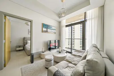 a living room with a couch and a tv at Daniels 2BR with Canal View at Aykon City in Dubai