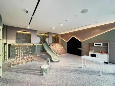 a childrens play room with a slide at Frank Porter - Oxford Gardens in Dubai