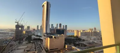 a view of a city with a tall building at Silk Valley - Luxury 1BR: Steps to Barasti Beach & Marina Walk in Dubai