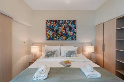 a bedroom with a large bed with two towels at Stylish 1BDR Fully Upgraded Near Burj Khalifa in Dubai