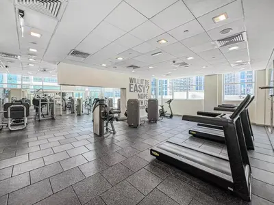 a gym with treadmills and machines in a room at Stylish 1BDR Fully Upgraded Near Burj Khalifa in Dubai