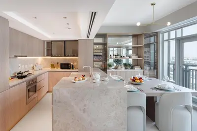 a kitchen with a large island in the middle at Stylish 1BDR Fully Upgraded Near Burj Khalifa in Dubai