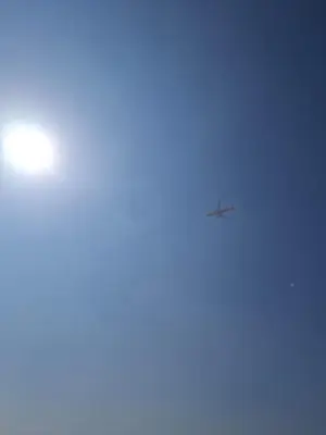 an airplane is flying in the sky at Equity Gate 217 in Dubai