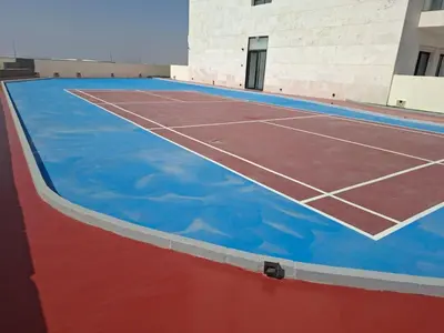 an empty tennis court with blue paint on it at Equity Gate 217 in Dubai
