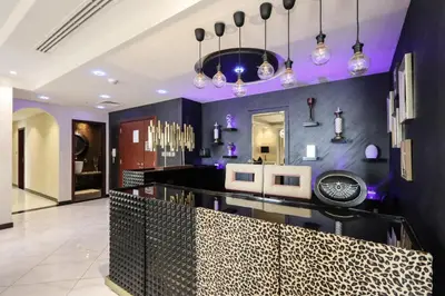 a dining room with purple walls and a black counter at Prime JBR 4B with Maid with Sea and Ain Dubai View in Dubai