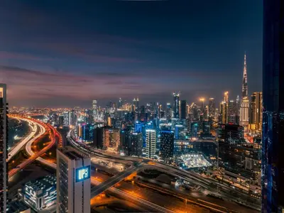 a city skyline at night with traffic at Hollywood Glamour Epic Burj Views at DAMAC Towers by Paramount in Dubai