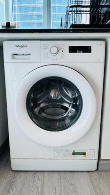 a white washing machine sitting in a kitchen at 1 Bedroom with Balcony - Near Metro - Fast Wi-Fi in Dubai