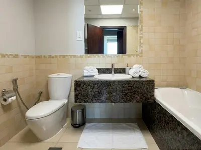 a bathroom with a toilet and a sink and a tub at Stunning Sea View - 2-BR - 2 min Walk to Beach in Dubai