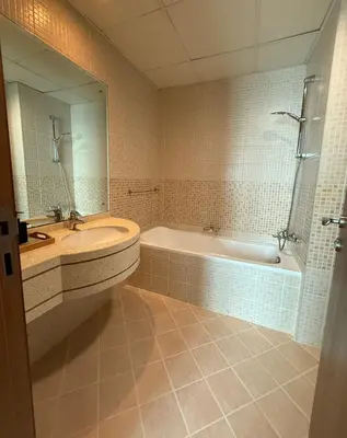 a bathroom with a tub and a sink and a bath tub at Palm Sea View - Dubai Marina- 2 Bedrooms in Dubai