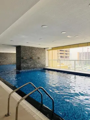 a swimming pool in a building with a large swimming pool at Palm Sea View - Dubai Marina- 2 Bedrooms in Dubai