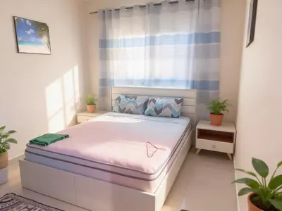 a bedroom with a bed in a room with plants at Vip private room ladies only in Dubai