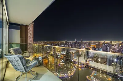 a room with a view of a city at night at Deluxe Marina Gate Suite with Sea and Ain Dubai View in Dubai