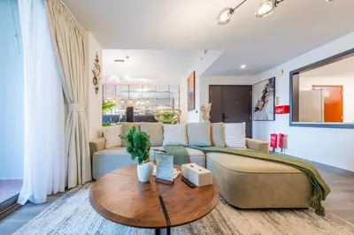 a living room with a couch and a table at Boutique 3BR in JBR Upgraded by UDH in Dubai