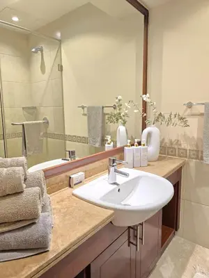 a bathroom with a white sink and a shower at Fairmont North Residences Palm Jumeirah in Dubai