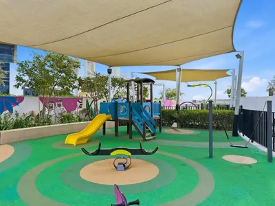 a playground with a slide and a play structure at DAMAC Maison Aykon City Dubai in Dubai