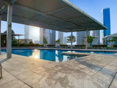 a swimming pool with a view of the city at Silkhaus Modern Studio in Central Park Tower DIFC in Dubai