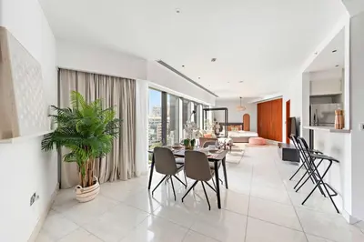 a dining room and living room with a table and chairs at Silkhaus Modern Studio in Central Park Tower DIFC in Dubai