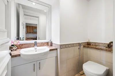 a bathroom with a sink and a toilet and a mirror at Renovated 2 Br in Golden Mile 5 Near Nakheel Mall in Dubai