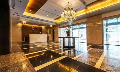a large lobby with a chandelier in a building at Cozy 2BR l Marina l Steps to Beach l Balcony l Pool in Dubai