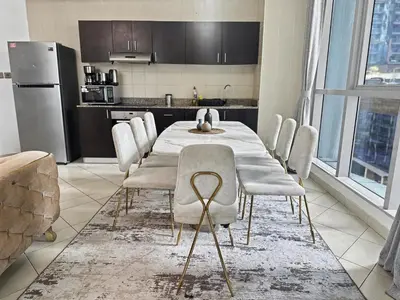 a dining room with a table and chairs in a kitchen at Cozy 2BR l Marina l Steps to Beach l Balcony l Pool in Dubai