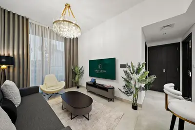 a living room with a couch and a tv at FIRST CLASS 1BR Luxury Comfort Prime Location in Dubai